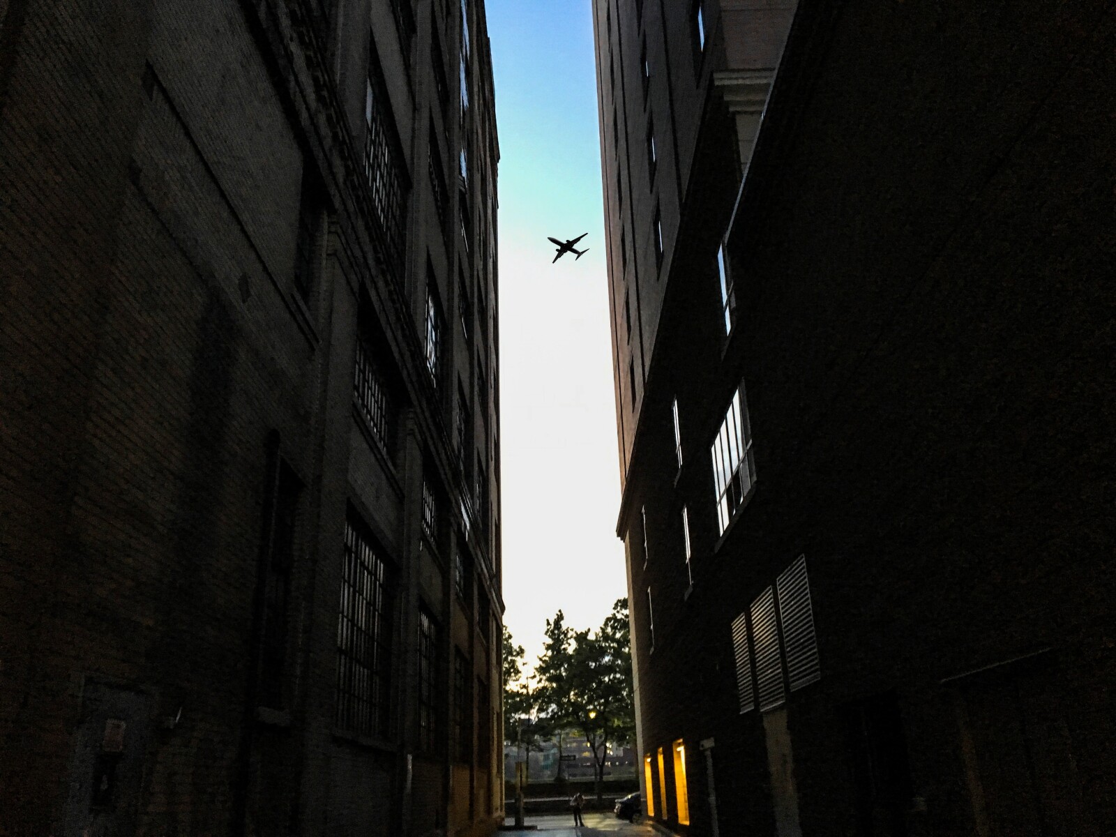 plane flying over buildings