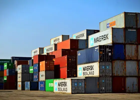 Ocean export shipping containers stacked at a port terminal for international freight transport