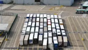Aerial view of dozens of freight trucks lined up at a cross-docking facility loading bay for logistics distribution